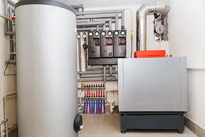 A Domestic Household Boiler Room with a New Modern Heating Oil Warm Water System and Pipes